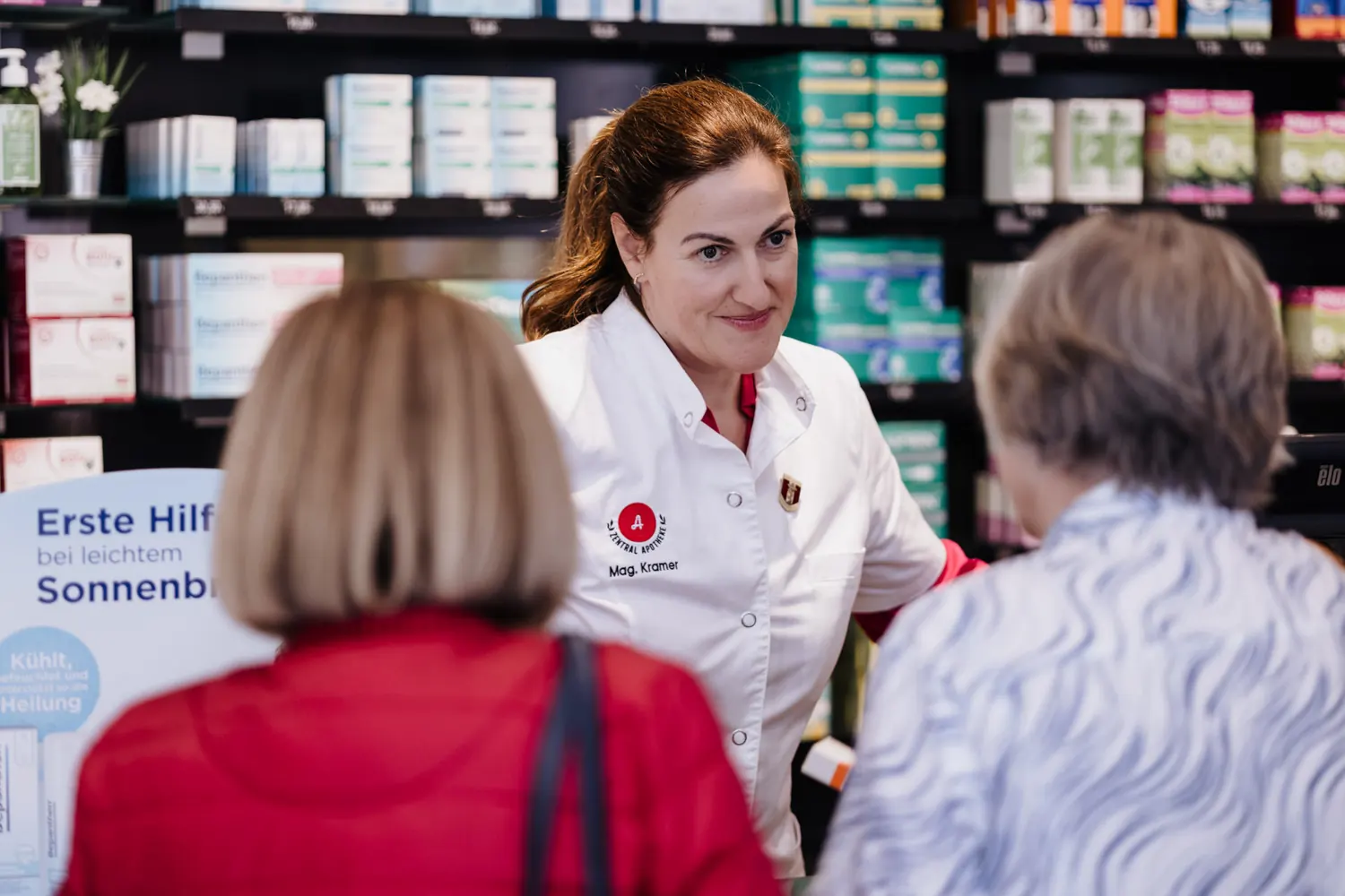 Eine Apothekerin berät zwei Kundinnen in der Offizin
