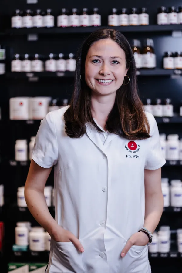 Porträt von Stefanie Würfl im weißen Kittel vor dem Apothekenregal